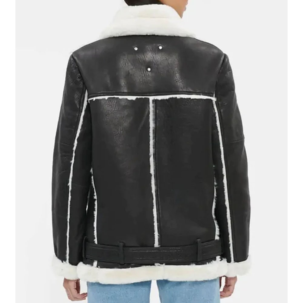 Women's black oversized shearling leather jacket with fake fur lining on the shoulders and a zipper closure. It features a leather shell, a collar, and two outside pockets.