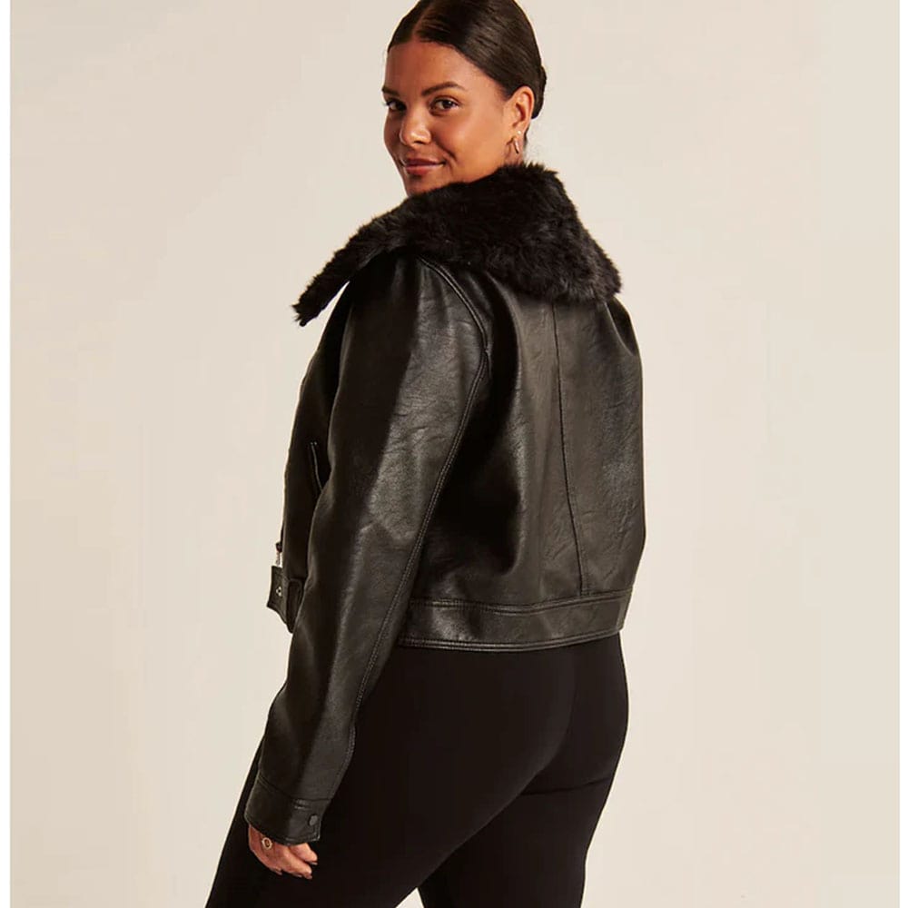 Women's black leather bomber jacket with faux fur lining at the collar and zipper pockets, displayed on a plain background.